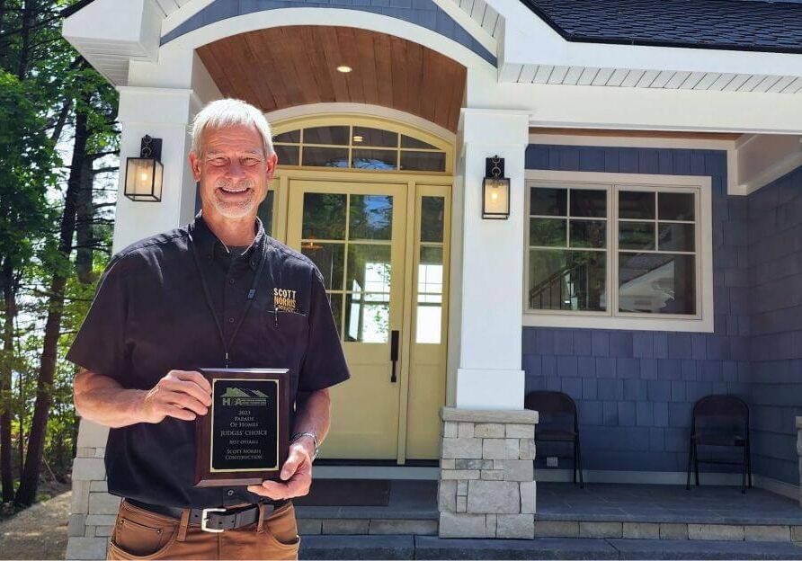 Scott Norris Holds an award for the 2023 Parade of Homes